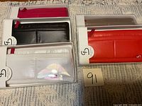 Five boxed wallets showing assortment of colors