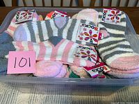 Plastic bin filled with multiple tagged slipper socks