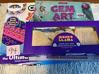 Three boxed craft kits stacked: Cra-Z-Art Ultimate Loom, Dan&Darci Gem Art Kids, Mondo Llama paint-your-own wood characters