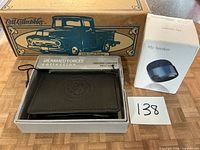 Front view showing boxed Ertl 1956 Ford Pickup, boxed USMC wallet, boxed portable speaker
