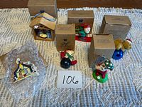 Group shot of six ornaments and four Avon boxes