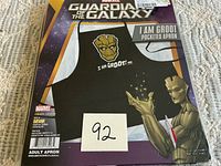 Front of sealed package showing full apron design and branding