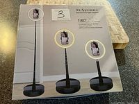 Front of product box showing ring light stand images and features