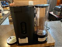 Full view of coffee maker with reservoir and drip tray