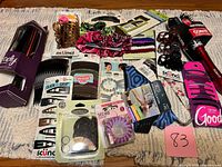 Overall lot view showing all packaged hair accessories and tools