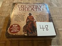 Front of sealed Country Greats tin