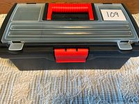 Closed toolbox front view showing red latch, clear lid organizers, 109 tag