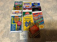 All nine sealed trading card packs laid out in three-by-three grid