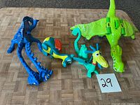 Group shot of all five toy dinosaurs on surface