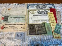 Group shot of all documents: checks, stock certificates, German note, ration coupons