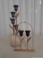 Full view of both Aarikka wooden flower pieces: vase arrangement and arch ornament