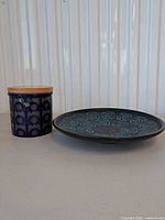 Arthur Wood jar with lid and West Germany plate side by side
