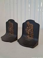 Front view of both bookends showing scholar design and black/gold finish