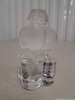 front angled view of crystal owl figurine on clear lobed base