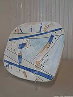 Front view of ceramic platter showing abstract design and colors