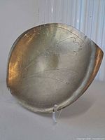 Front view showing asymmetrical shape and etched design