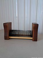 Front view of wood end blocks and metal coil record stand