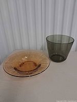 Front view of both items: pink footed console dish and smoky green bowl