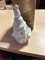 Front and side view of white porcelain church ornament with original box