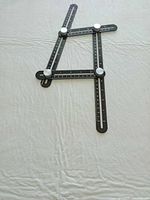 ruler arranged to show adjustable arms and scales