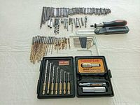 Entire lot laid out: loose bits, Speed-Lok case, Allen keys, ratchet screwdriver, bevel square