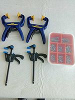 Group shot of two Irwin spring clamps, two Mastercraft bar clamps, and IKEA FIXA screw box
