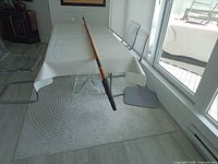 Full view of telescopic pole laid out showing overall length and color
