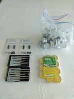 All items grouped: two knob packs, two screwdriver sets, bag of tealights, Blitz citronella tealights