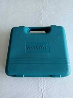 Closed Makita teal case front view