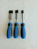 Front view of three Mastercraft chisels with caps