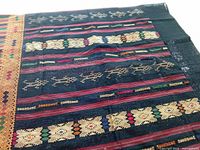 Full view of woven skirt showing horizontal patterned bands