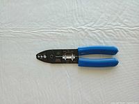 Full view of wire stripper showing entire tool and blue handles