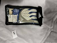 Front of sealed pouch showing Adidas junior goalkeeper gloves