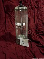 Full view of Barbicide glass jar showing branding and overall condition