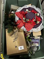 Top view of tote showing wreath, boxed item, greenery, gift box, sealed nativity package