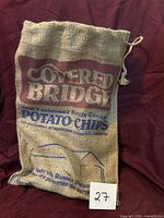 Front view of burlap sack showing graphics and drawstring
