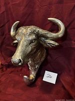 Front view showing buffalo head shape, horns, and hook