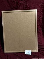 Front view of framed cork peg board