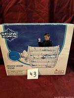 Front of sealed box showing Snow Zone branding and product image