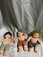 Front view of three Ty Beanie Kids dolls showing hair colors, shorts and swing tags
