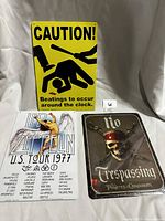 All three metal signs laid out front view