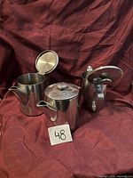 Front view of all three stainless teapots