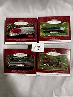 Front view of four Hallmark Keepsake Lionel locomotive ornament boxes