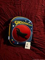 Front view of blue and yellow insulated lunch bag with superhero motif