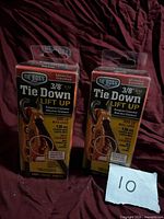 Front view of two sealed Tie Boss boxes showing product details