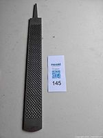 Full view of flat wood rasp showing tang and coarse teeth