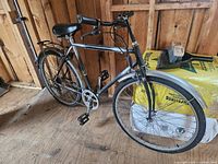 Full left side view of bicycle showing frame, wheels, fenders, and rack
