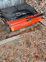 Front view showing hopper bag torn, tow arm attached, overall wear