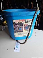 Full view of blue heated bucket with cord and worn label