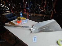 Full view of aluminum scoop shovel on table